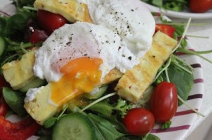 Nutrition Plans | A green salad with poached egg on top.